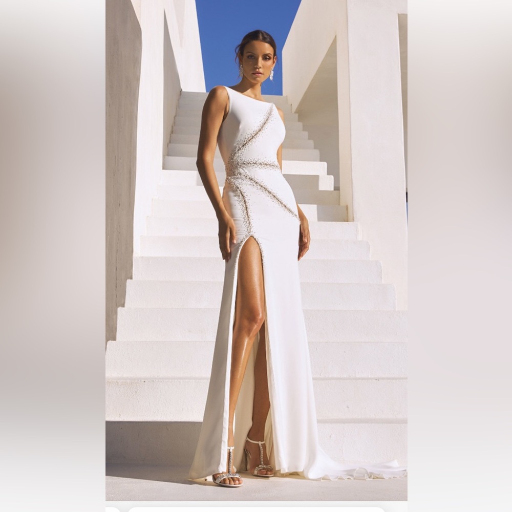 Pronovias Alaia is a striking crepe wedding dress featuring linear beading.